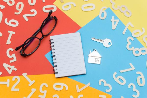 Numbers, a key, a house, spectacles and a notebook